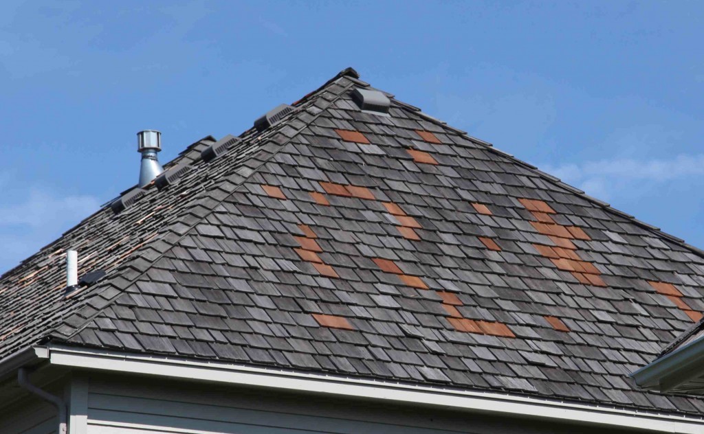 Minneapolis wood roof repair contractor installs new cedar shakes on old roof